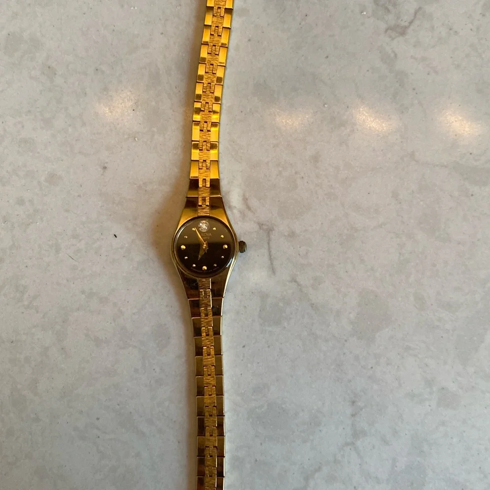 Bulova 14 k Gold filled, Quartz with Black face and small Diamond. France stamp.