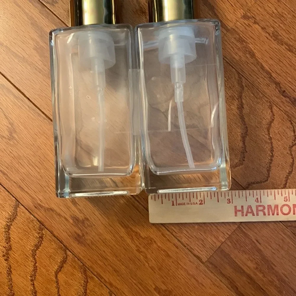 Set of TWO pump bottle refillable dispensers with goldtone tops