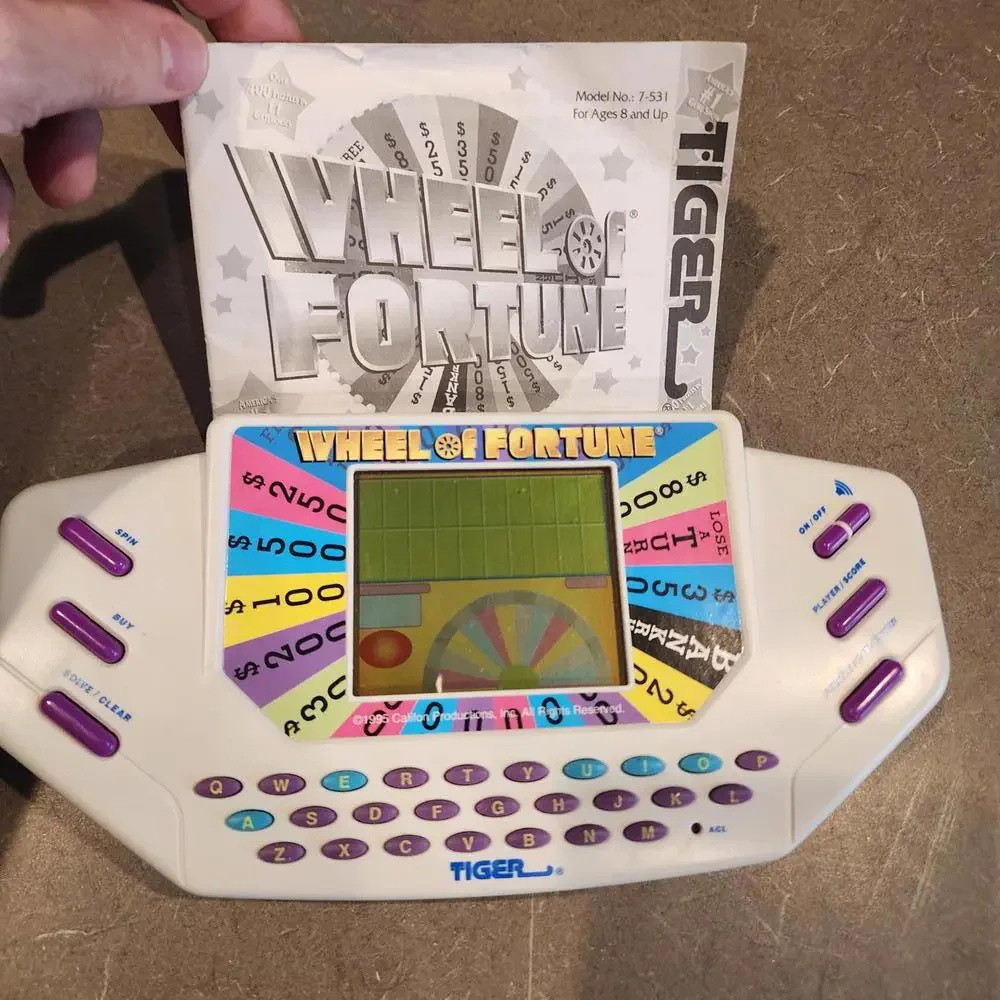 Wheel of Fortune Handheld Electronic Game works perfect EUC condition booklet