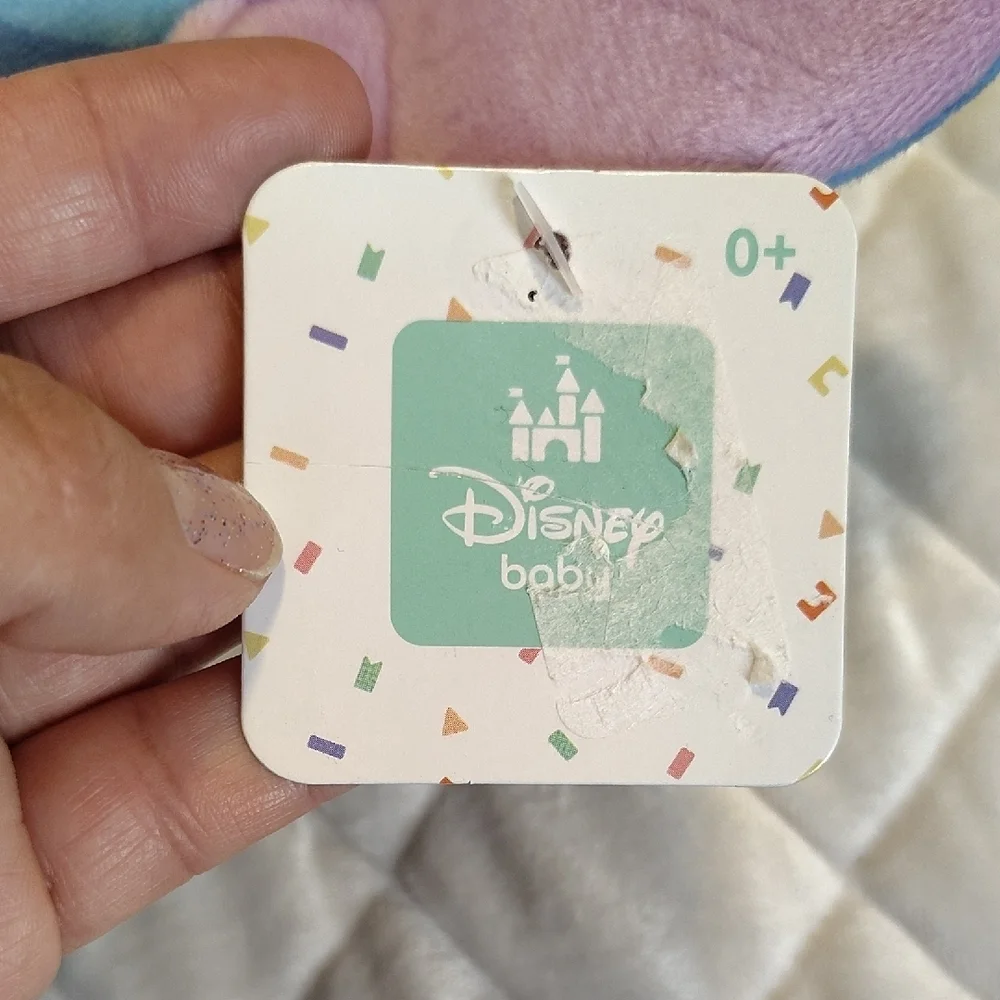 Disney Stitch Holding A Duck Soother Plush With Squeaker And Crinkle Material.