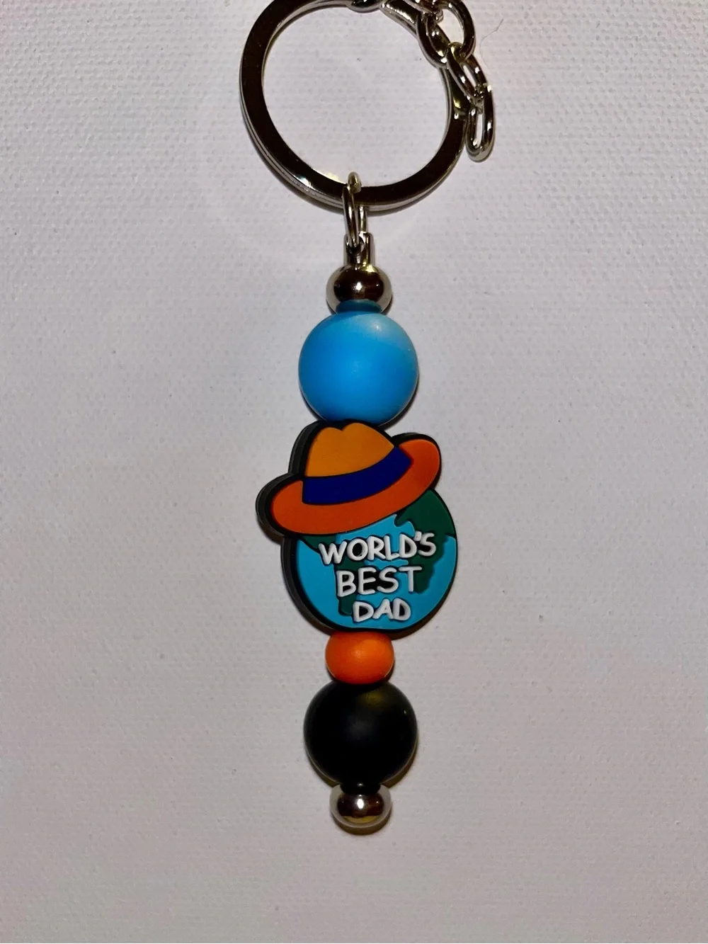 ‘World's Best Dad’ Globe w/Hat Charm Keychain in Blue, Orange & Black