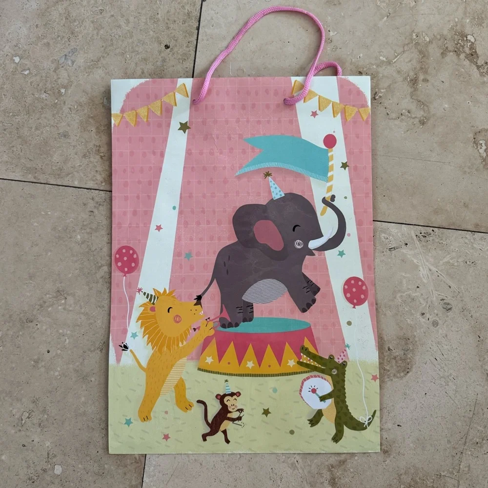 pink baby shower gift bag with circus scene