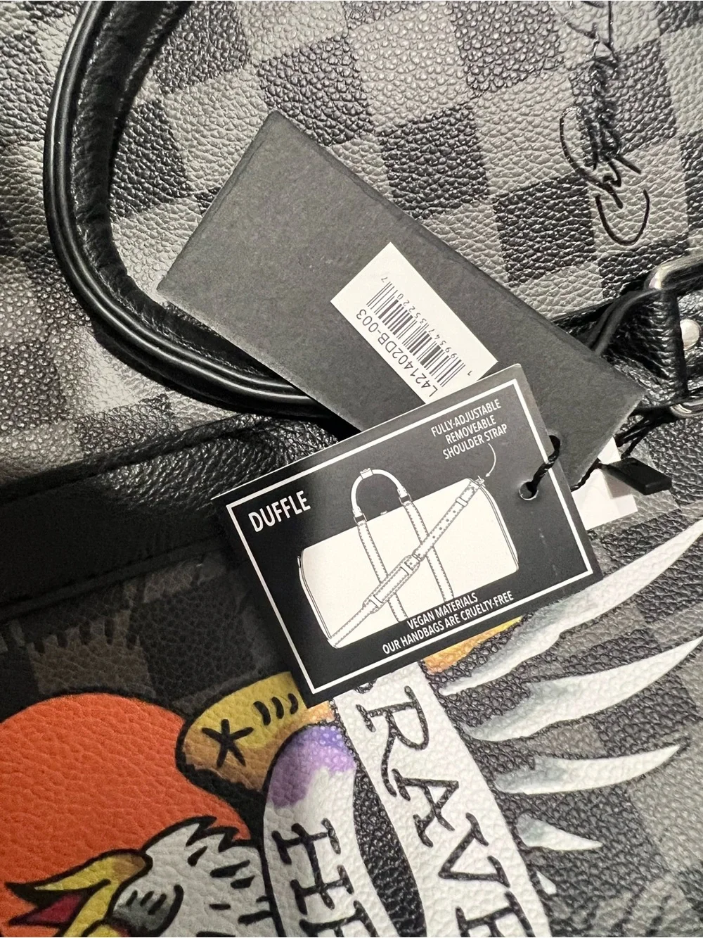 Ed Hardy duffel bag features a black and grey checkered pattern