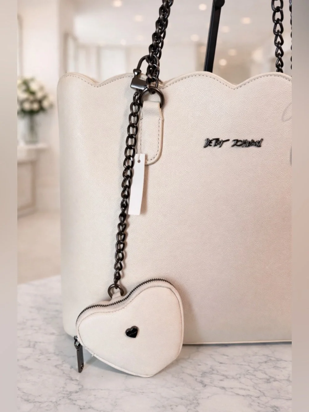 Betsey Johnson cream-colored tote bag black chain straps and heart-shaped charm