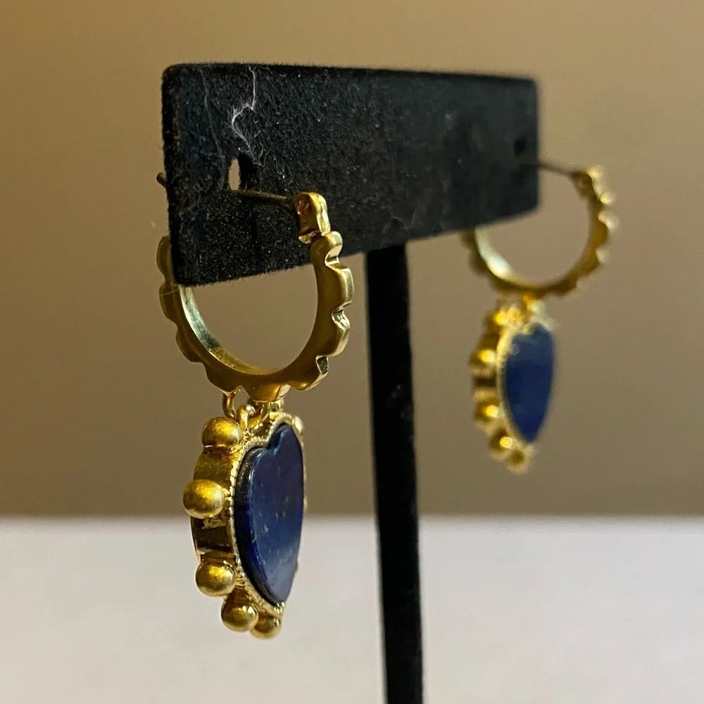 Tory Burch blue lapis heart drops hanging from huggie hoops.