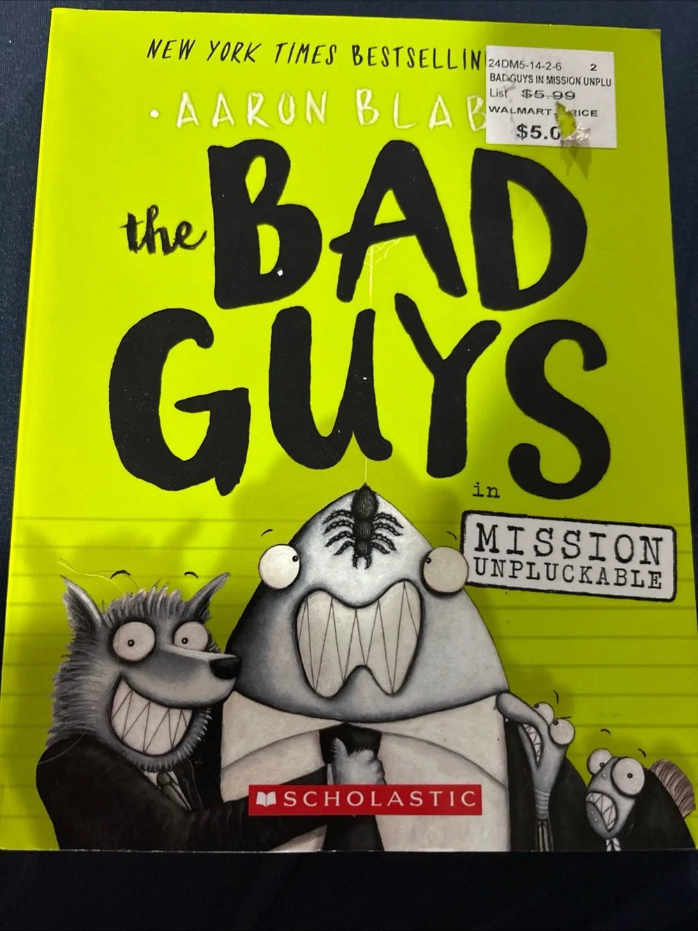 Scholastic Black Book Back Cover with Yellow and White Text