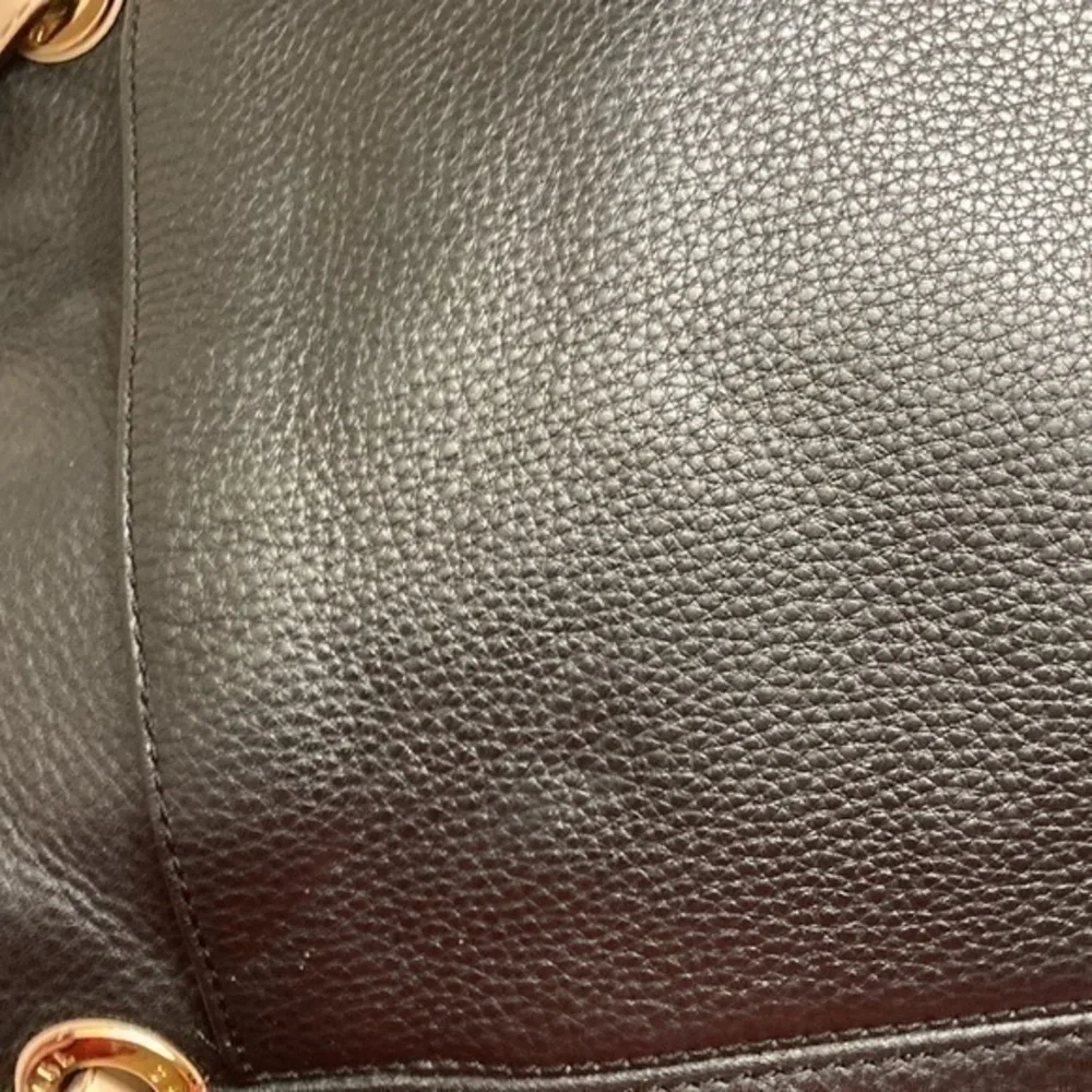 Michael Kors indentations darkened scratches