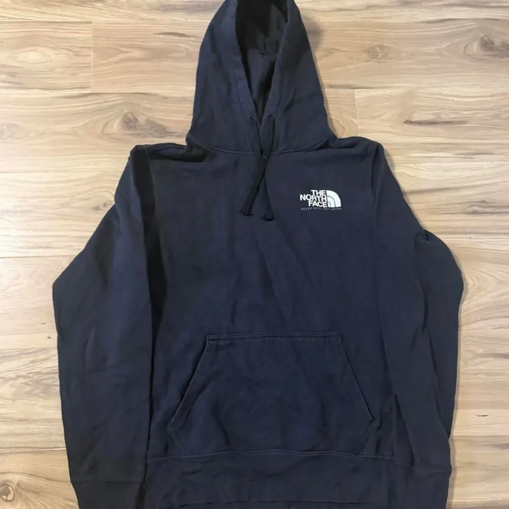The North Face black hoodie white logo 'NEVER STOP EXPLORING' SIze Small baggy