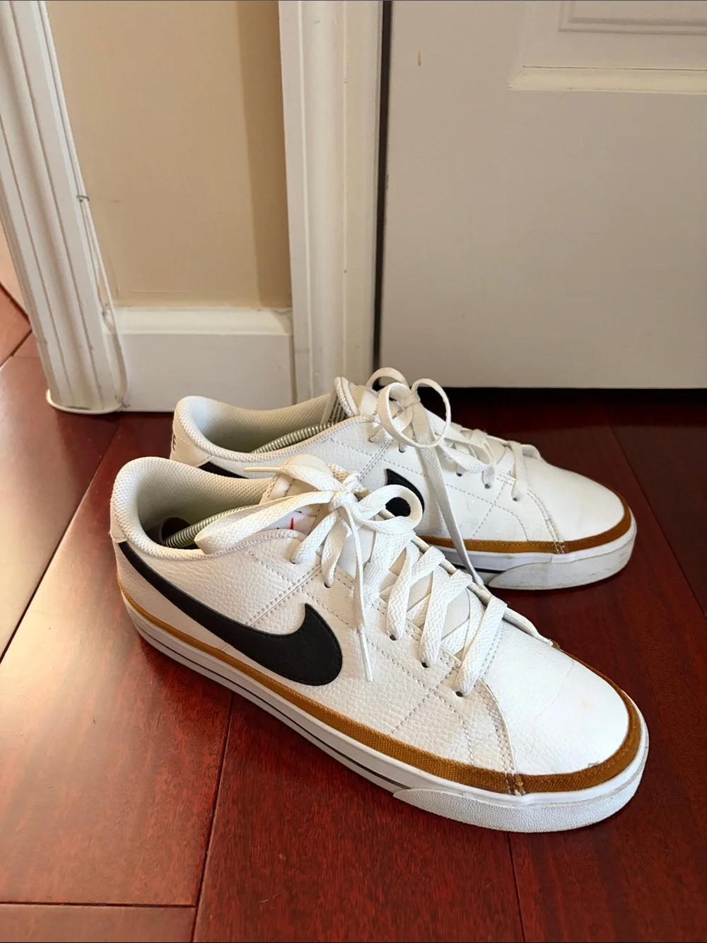 Nike WoMen’s White Sneakers with Black Swoosh and Gold Trim