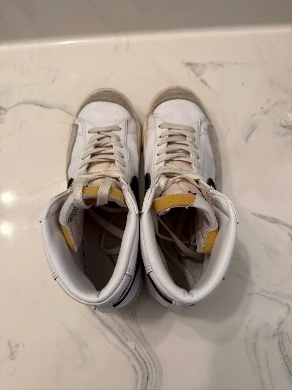 Nike White Sneakers with Black Swoosh and Red Nail Accent