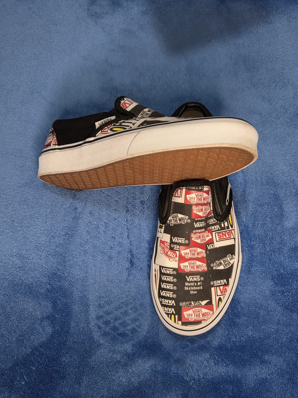 Vans Slip-On Skate Shoes in Black & White with Red Logo Print
