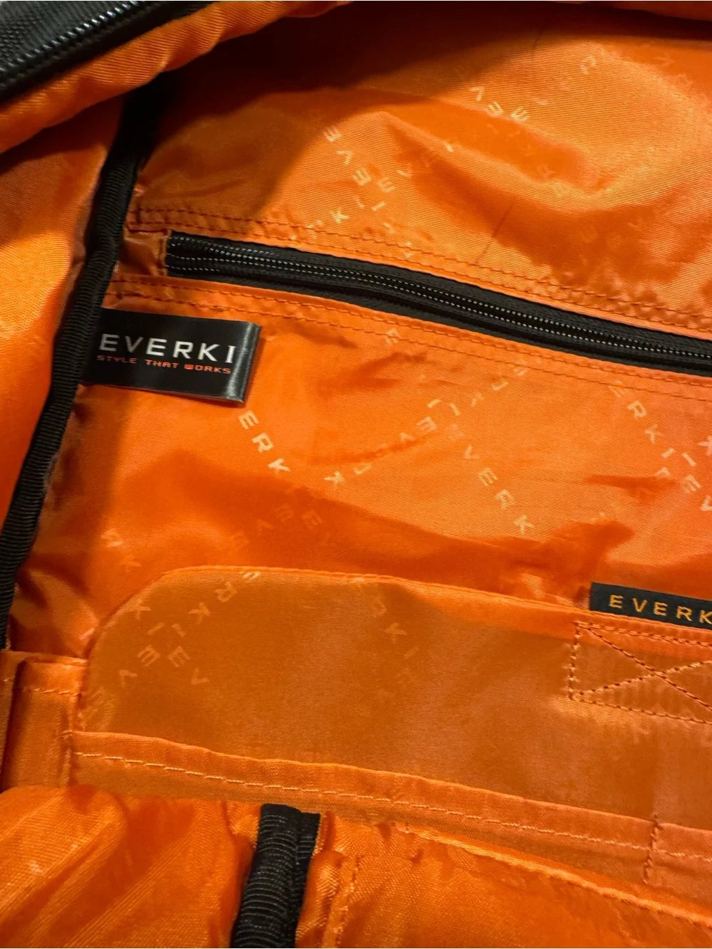 Black Men's Travel Backpack with Orange Accents Everki large laptop bag.
