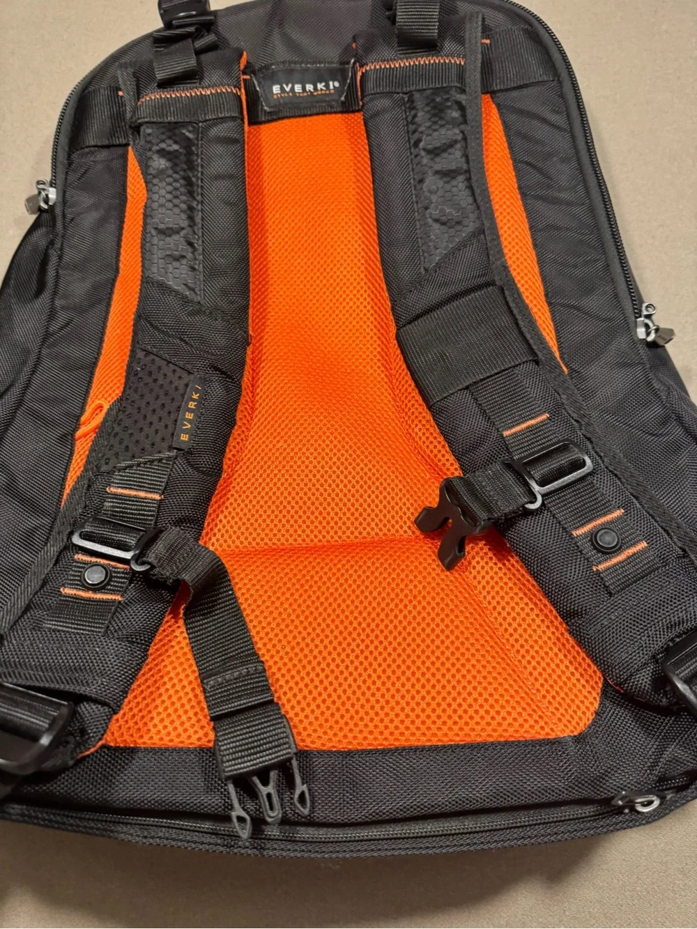 Black Men's Travel Backpack with Orange Accents Everki large laptop bag.