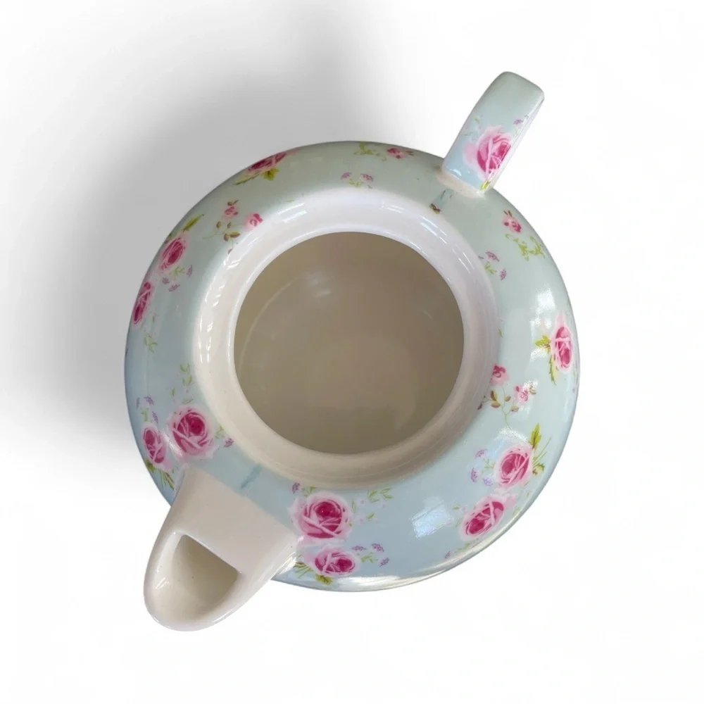 Small teapot with it’s own cup, charming, blue with roses, no flaws