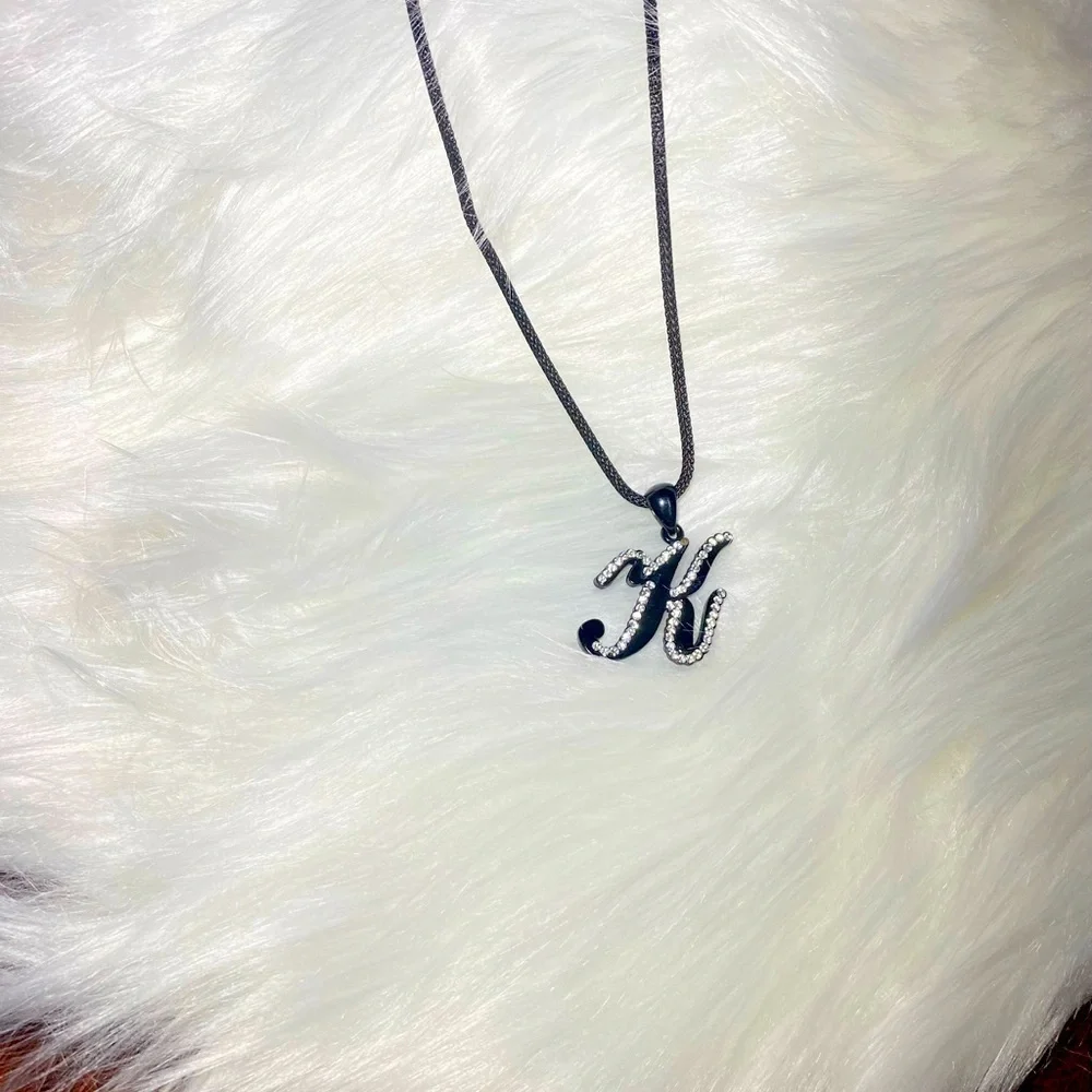 Necklace letter K in cursive‎ writing black with rhinestones on a black chain