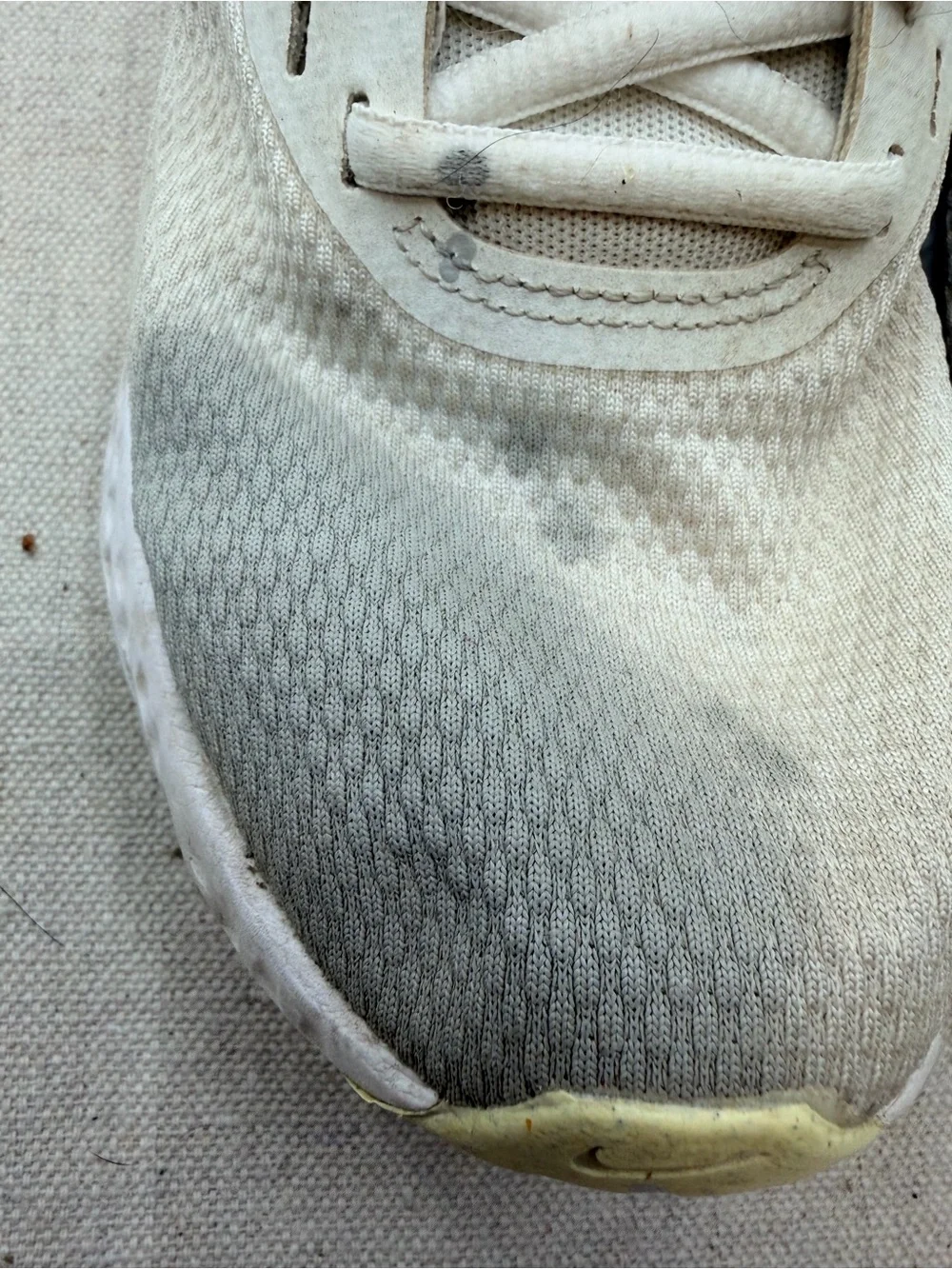 Nike Women’s Revolution Sneakers in Cream with Light Purple Swoosh