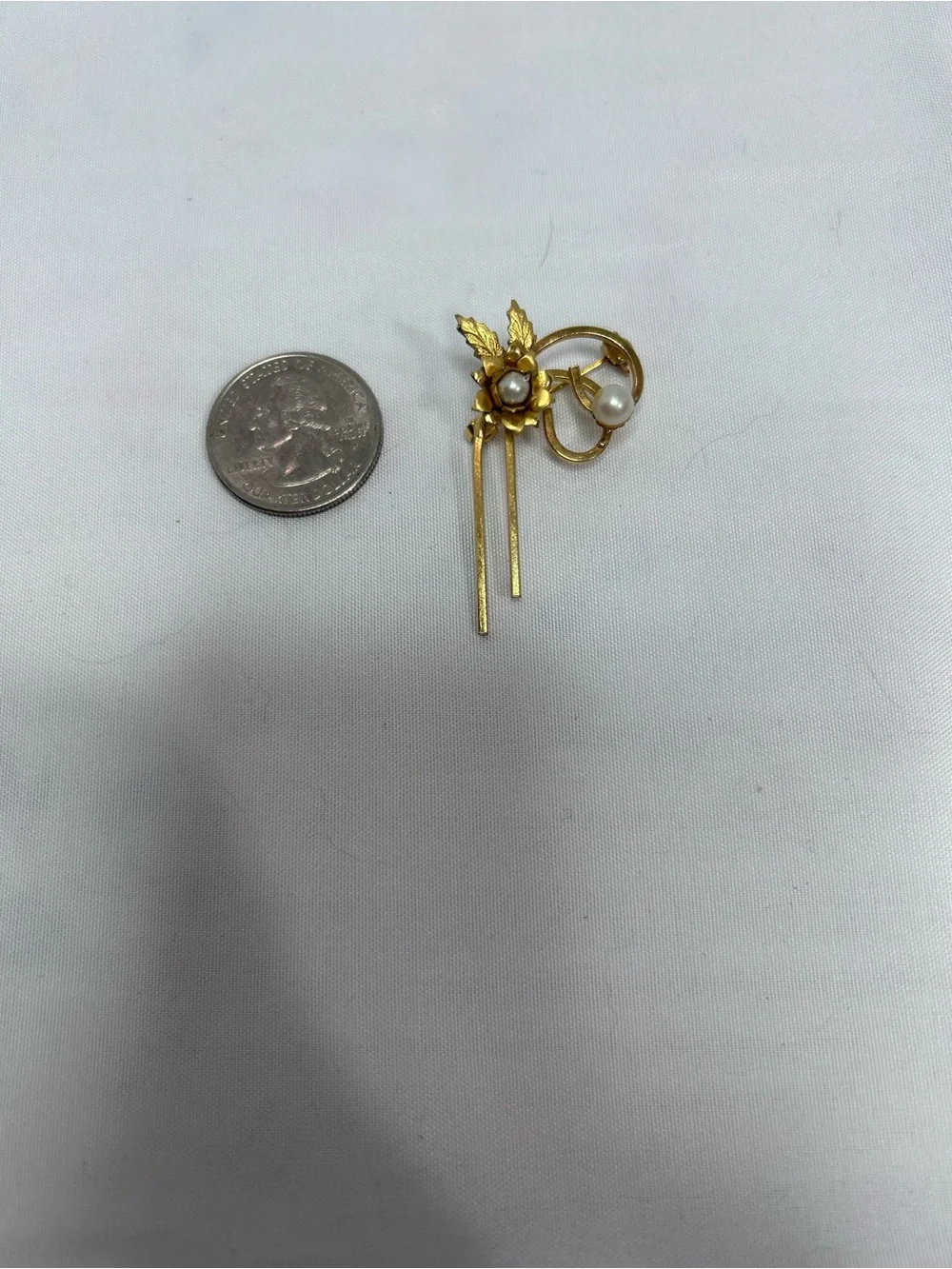 Delicate gold tone flower pin