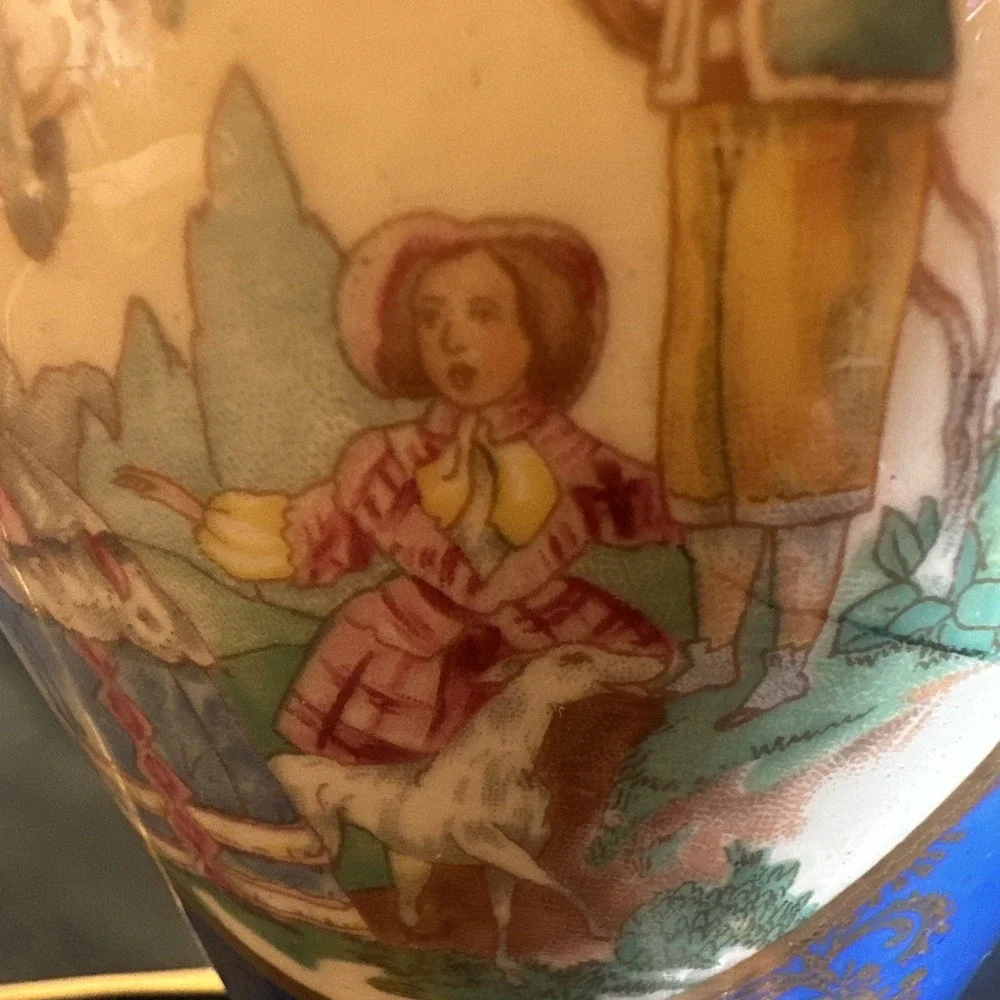 Antique porcelain urn lamp with grape-picking scene.