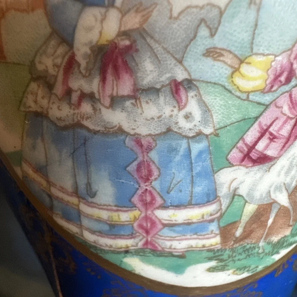 Antique porcelain urn lamp with grape-picking scene.