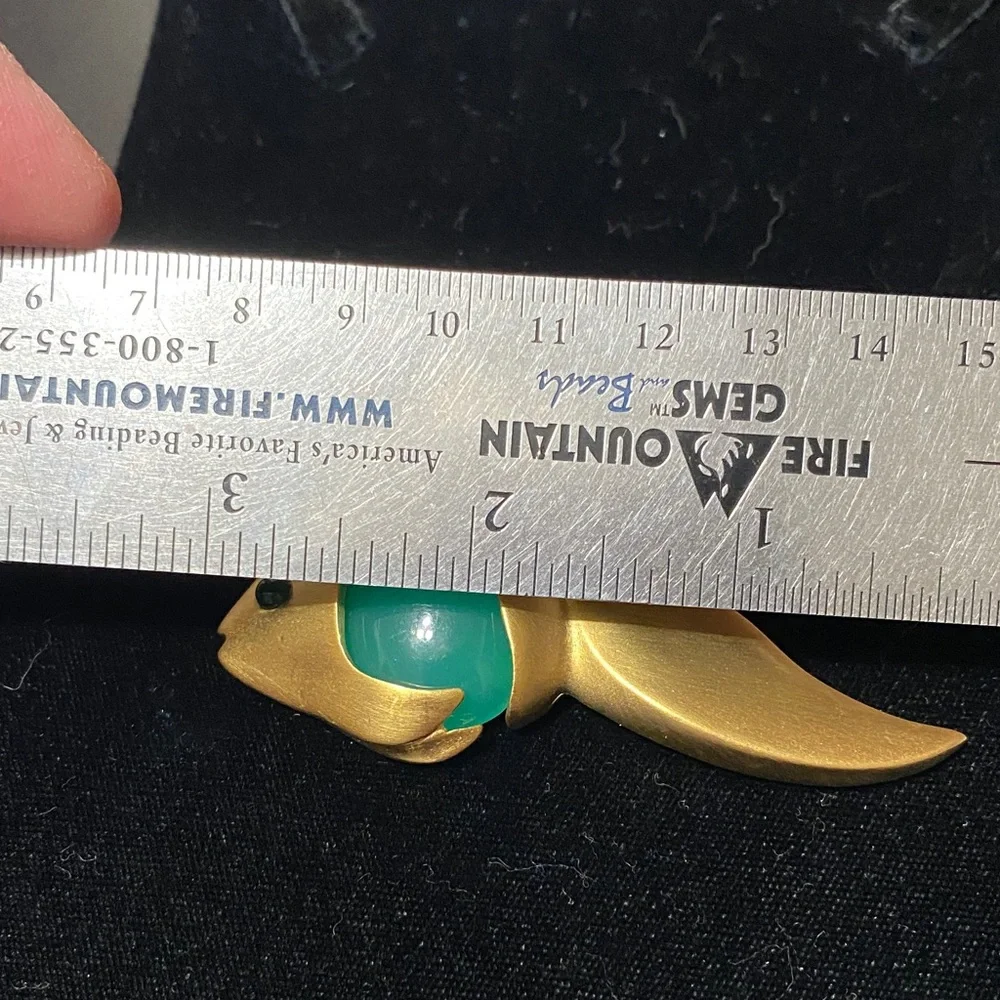 Givenchy vintage Matt gold tone with faux jade belly and eye brooch