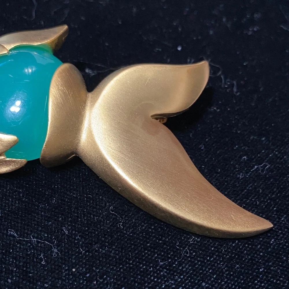 Givenchy vintage Matt gold tone with faux jade belly and eye brooch
