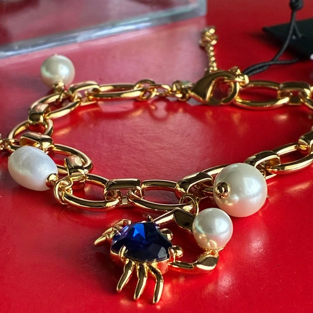 kate spade Gold-Tone Bracelet with Blue Crystal and Pearl Charms