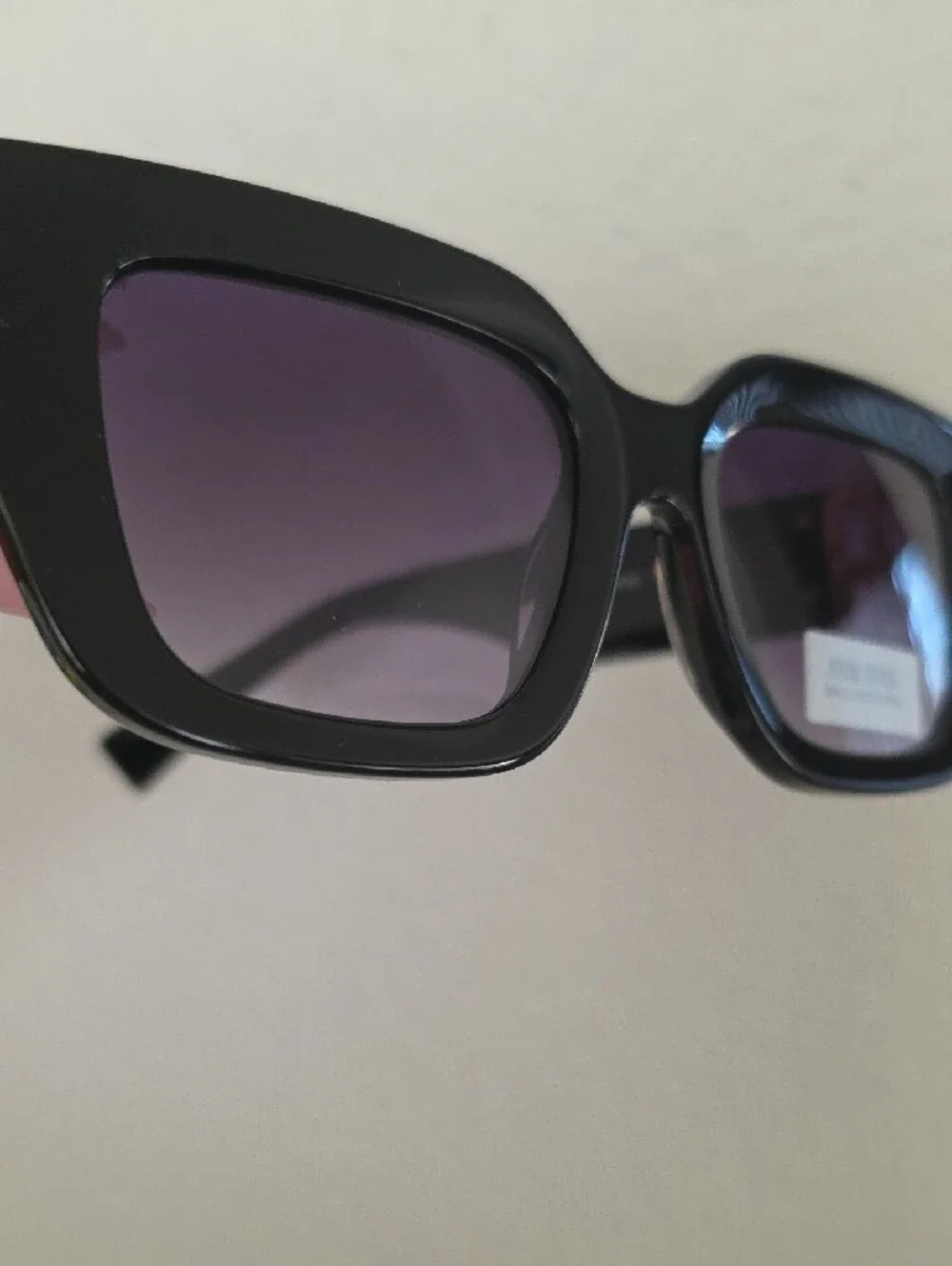 Miu Miu Glossy Black Frame Sunglasses with Purple Lenses