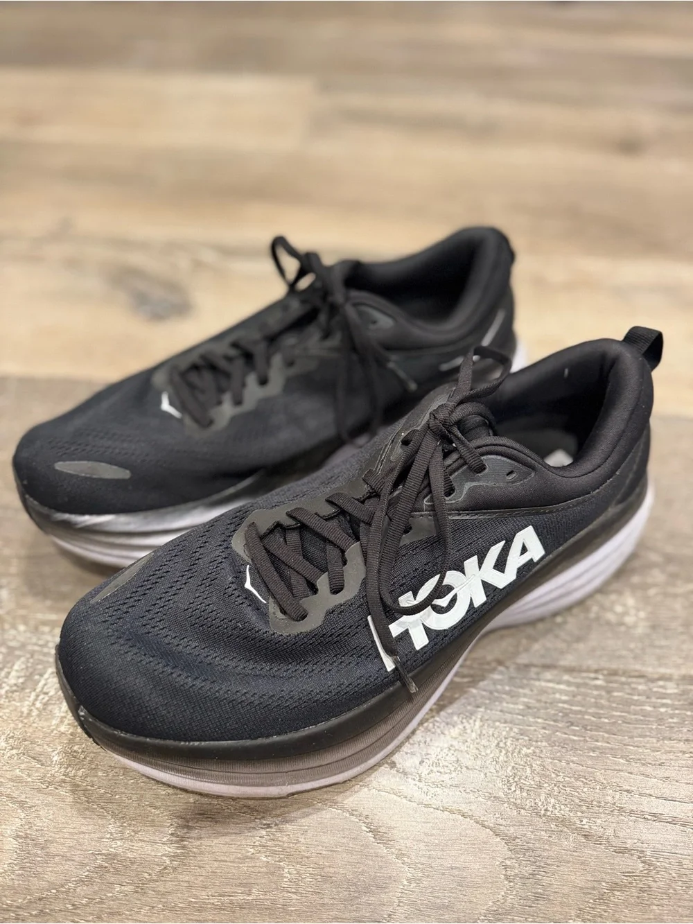 Hoka One One Bondi 8 running shoes feature a black upper and a white midsole