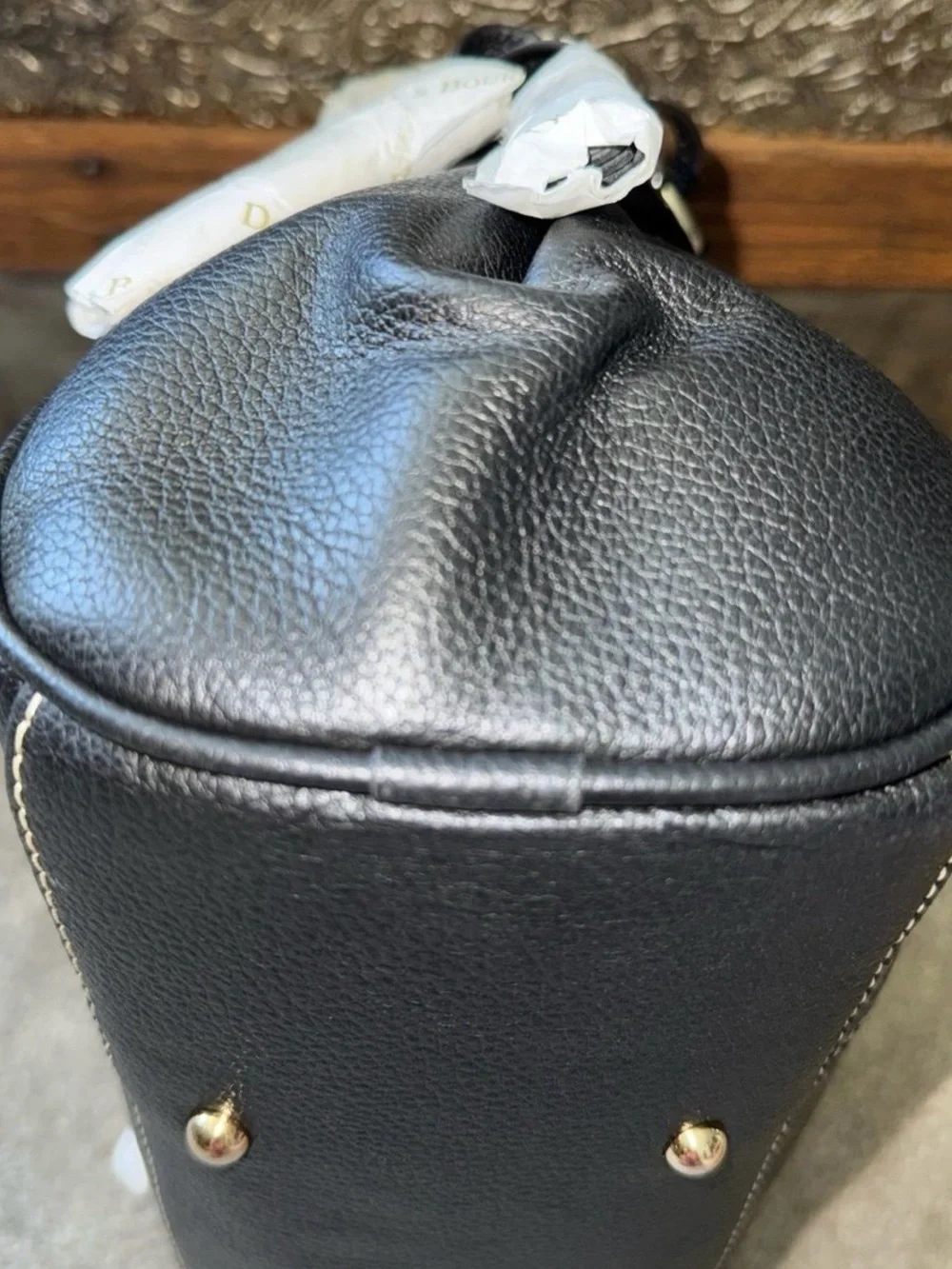 Dooney & Bourke plaque stitching pebble