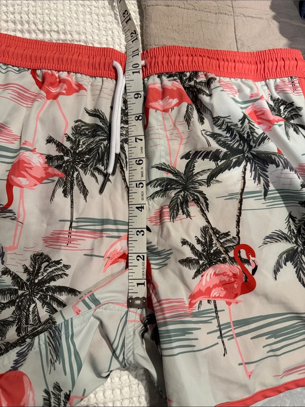 Maamgic flamingo print swim trunks feature a vintage 80s-90s style with a contra