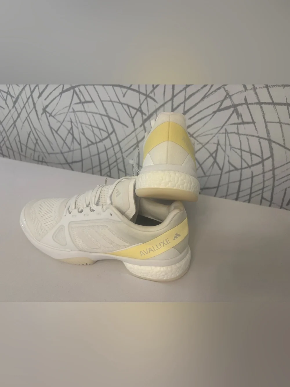 adidas Avaluxe tennis shoes in white with subtle pastel yellow accents. JQ7080