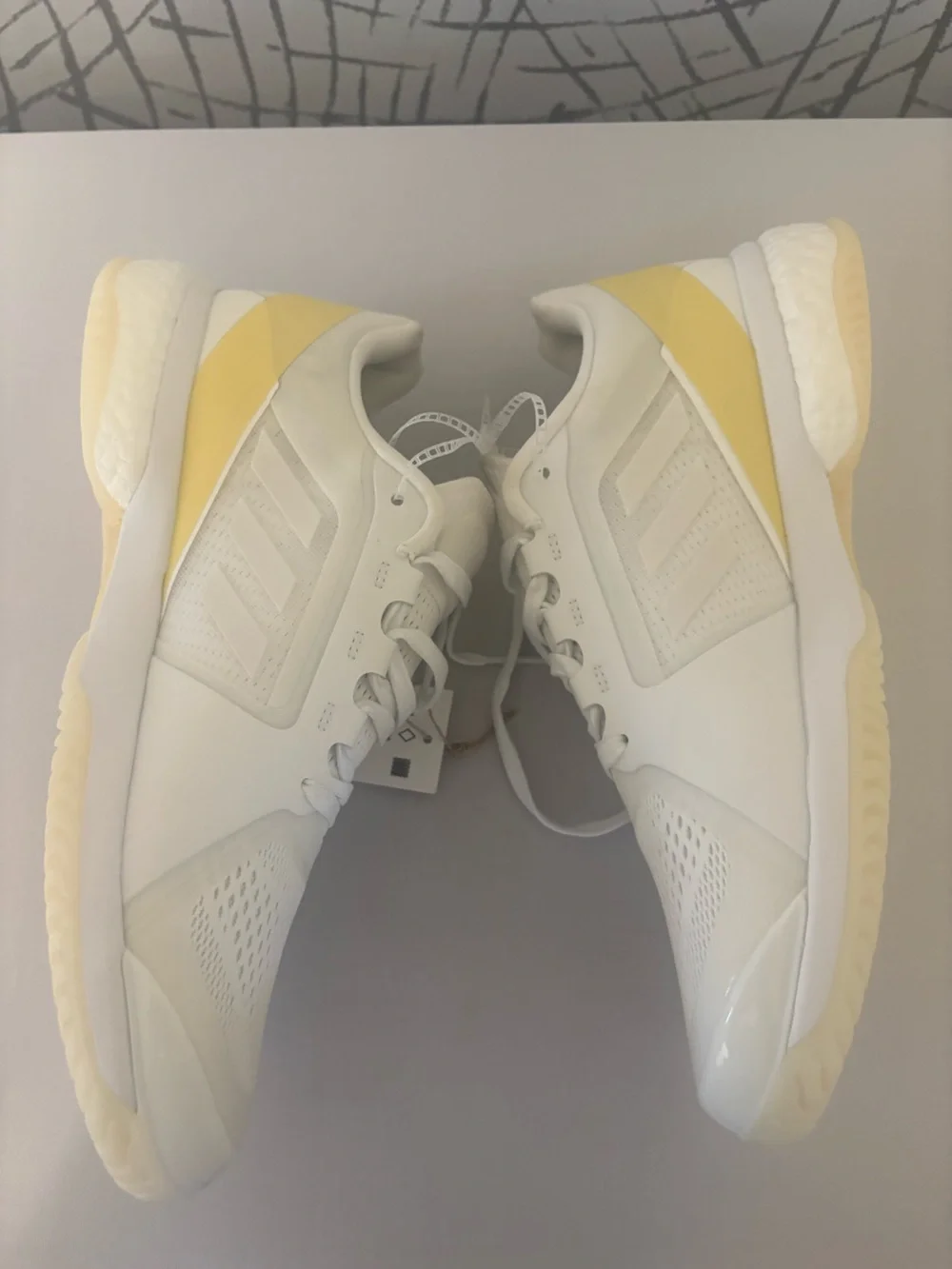 adidas Avaluxe tennis shoes in white with subtle pastel yellow accents. JQ7080