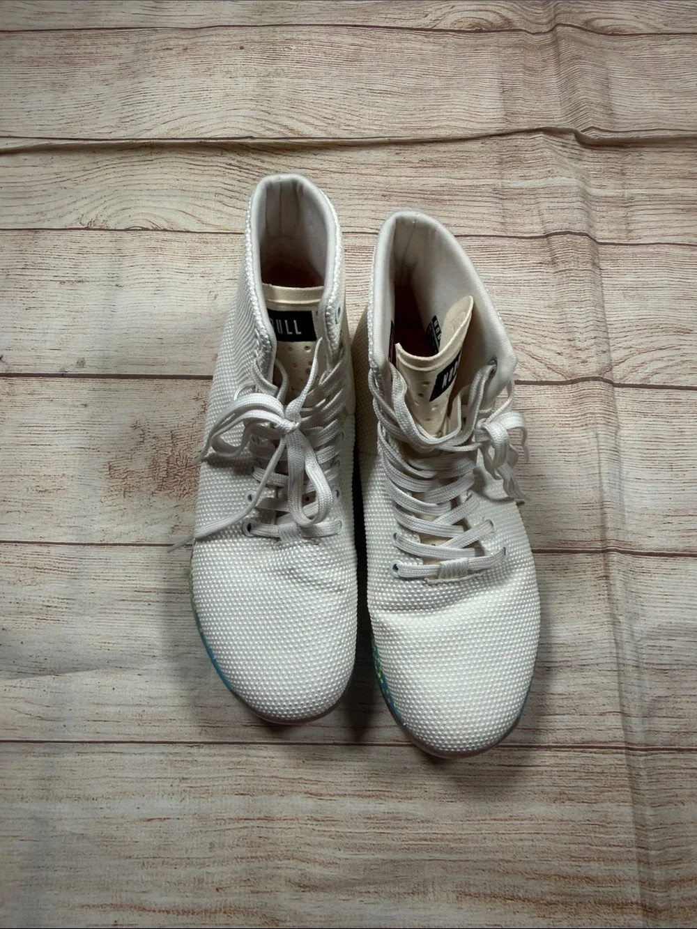 NOBULL‎ white high-top trainers featuring a vibrant multi-color glitch sole