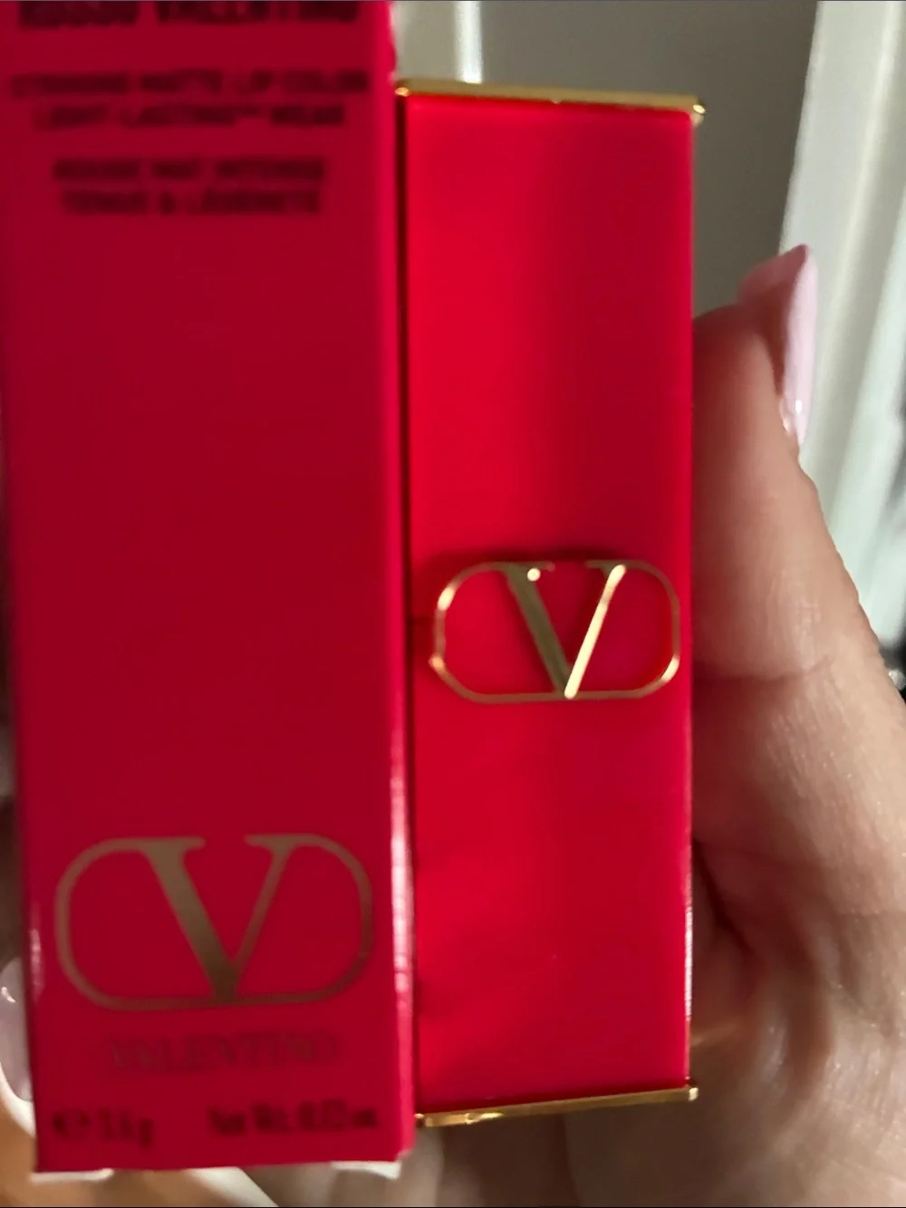 Valentino red lipstick with gold V-logo hardware