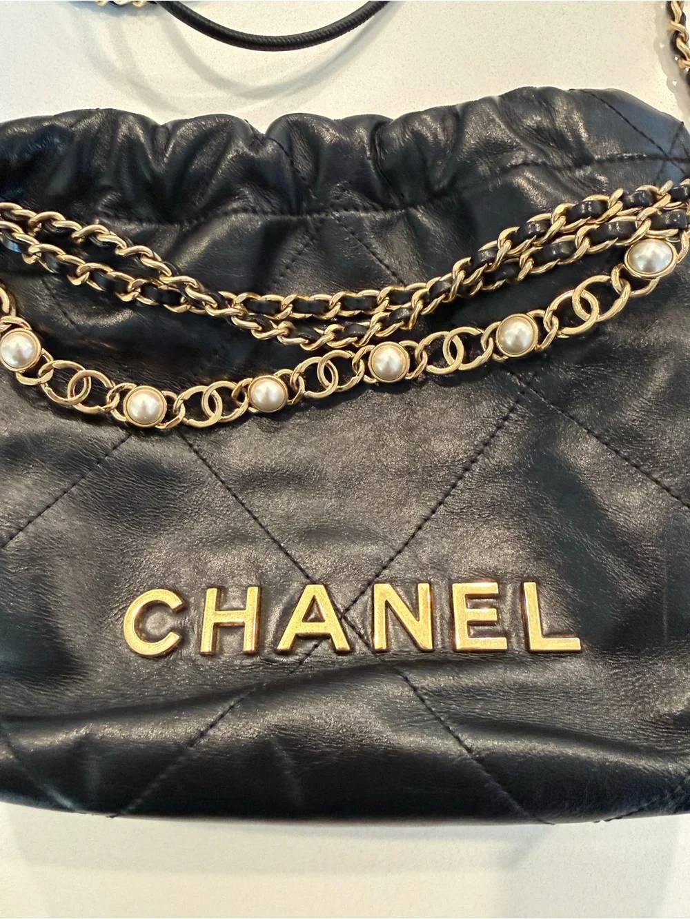 CHANEL 22 Black Quilted Leather Crossbody with Pearl-Trim Chain