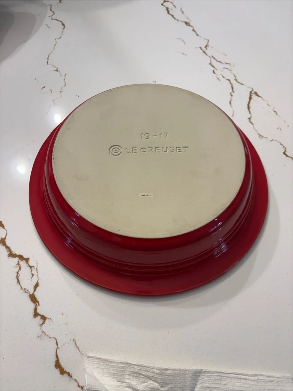 Le Creuset Cerise Red pie baking dish featuring a cream-colored interior.