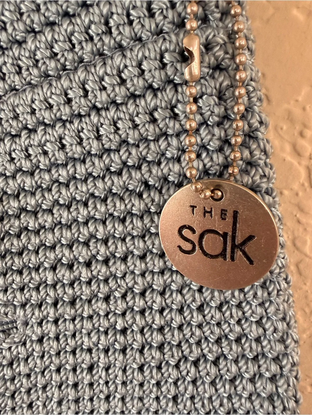 The Sak Light Gray Crochet Crossbody with Logo Charm