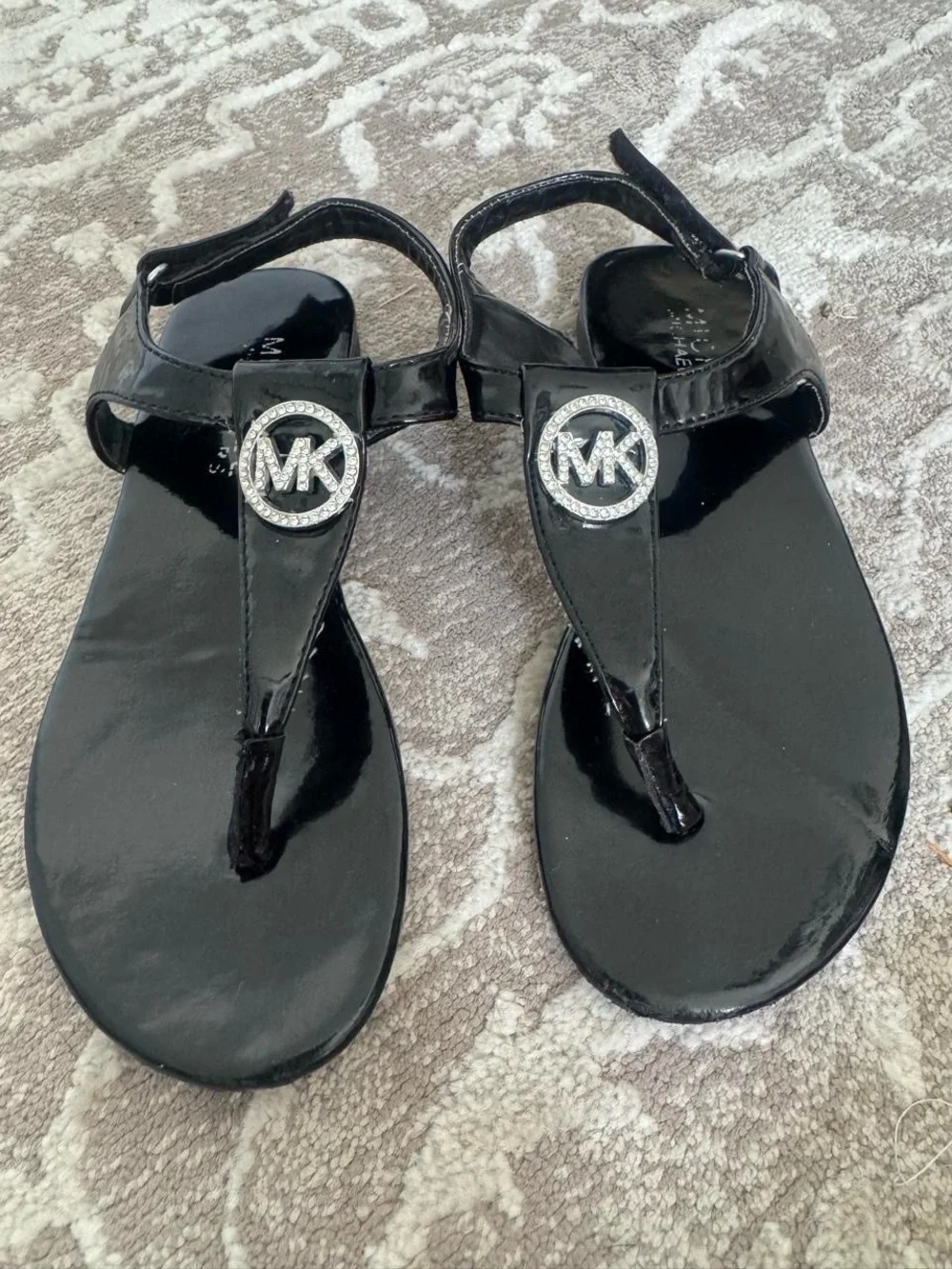 Michael Kors Black Patent T-Strap Sandals with Crystal MK Medallion