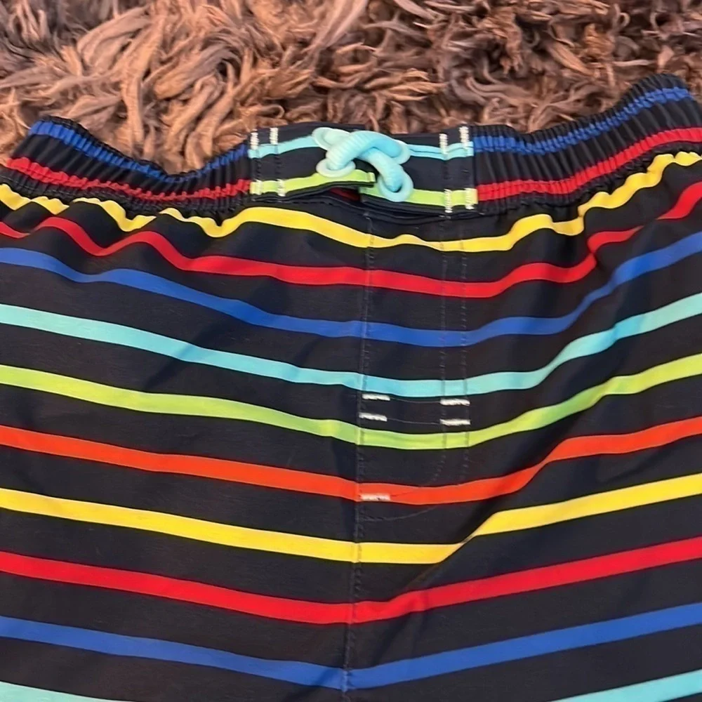Wonder nation size 4T swim trunks.  Blue background with colorful stripes