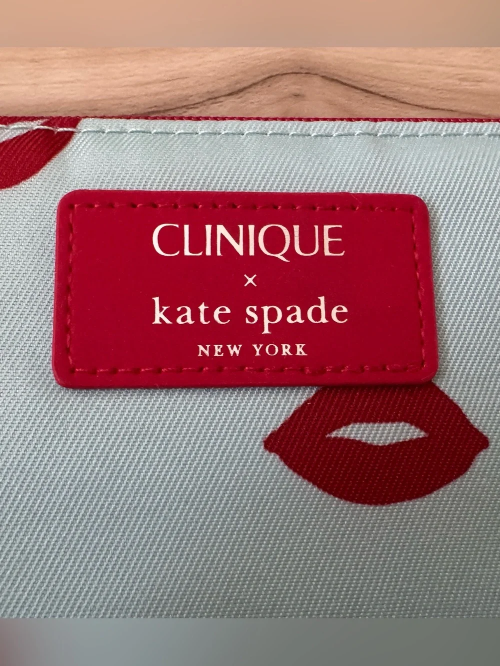 Clinique x kate spade Cosmetic Pouch in Light Blue with Red Lip Print