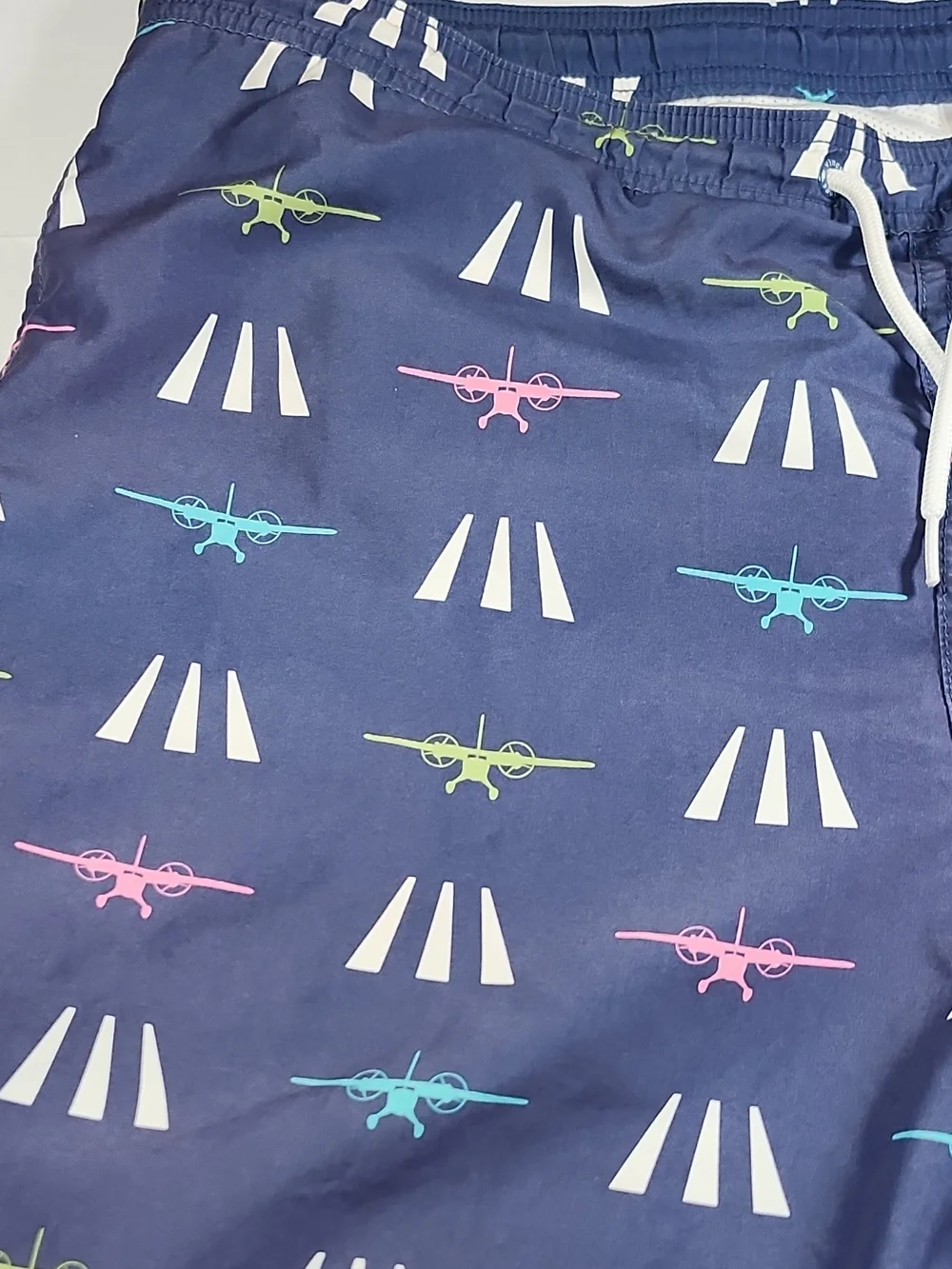 Vineyard Vines Navy Swim Trunks with Pink, Teal & Lime Plane Print