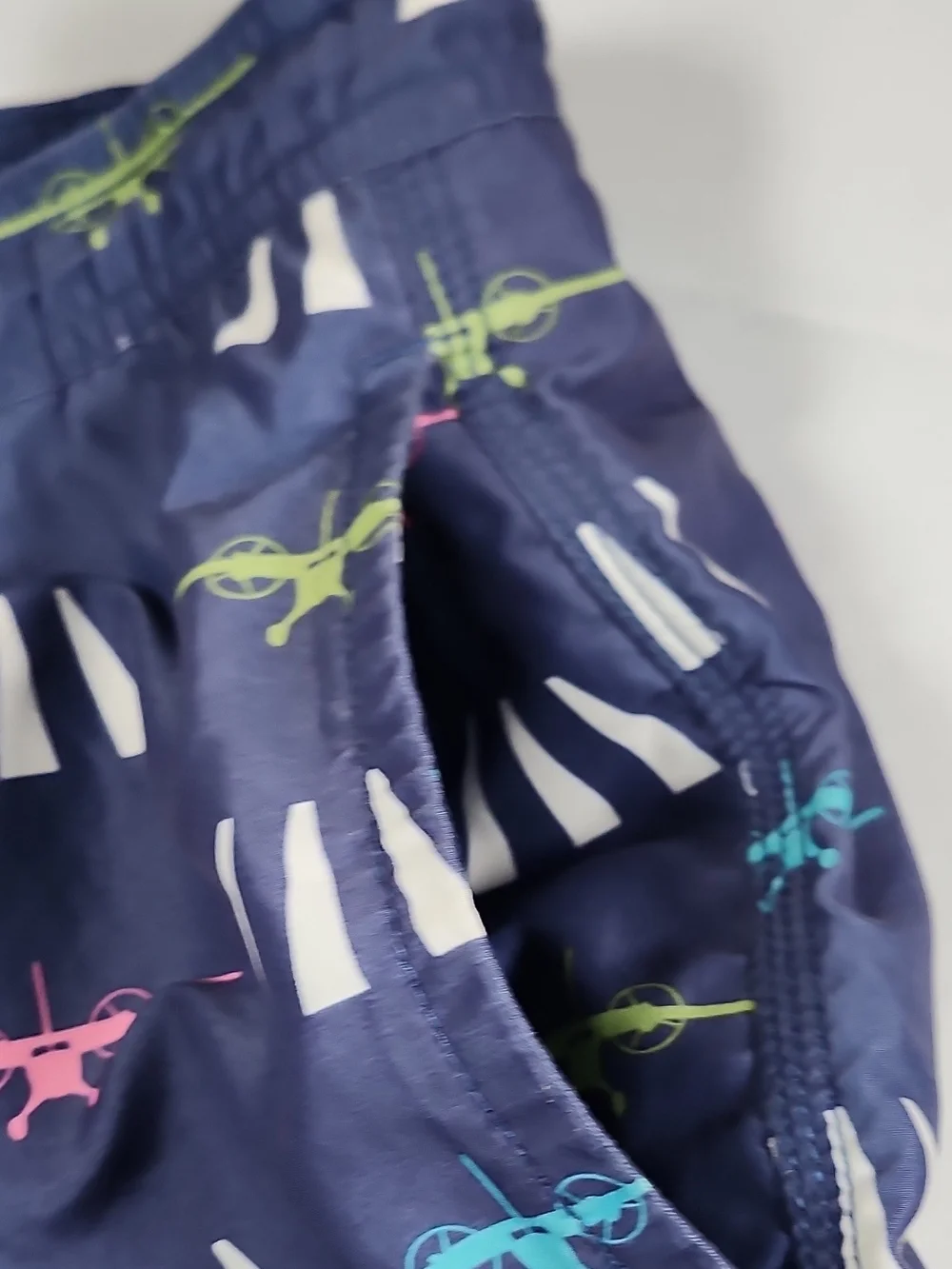 Vineyard Vines Navy Swim Trunks with Pink, Teal & Lime Plane Print