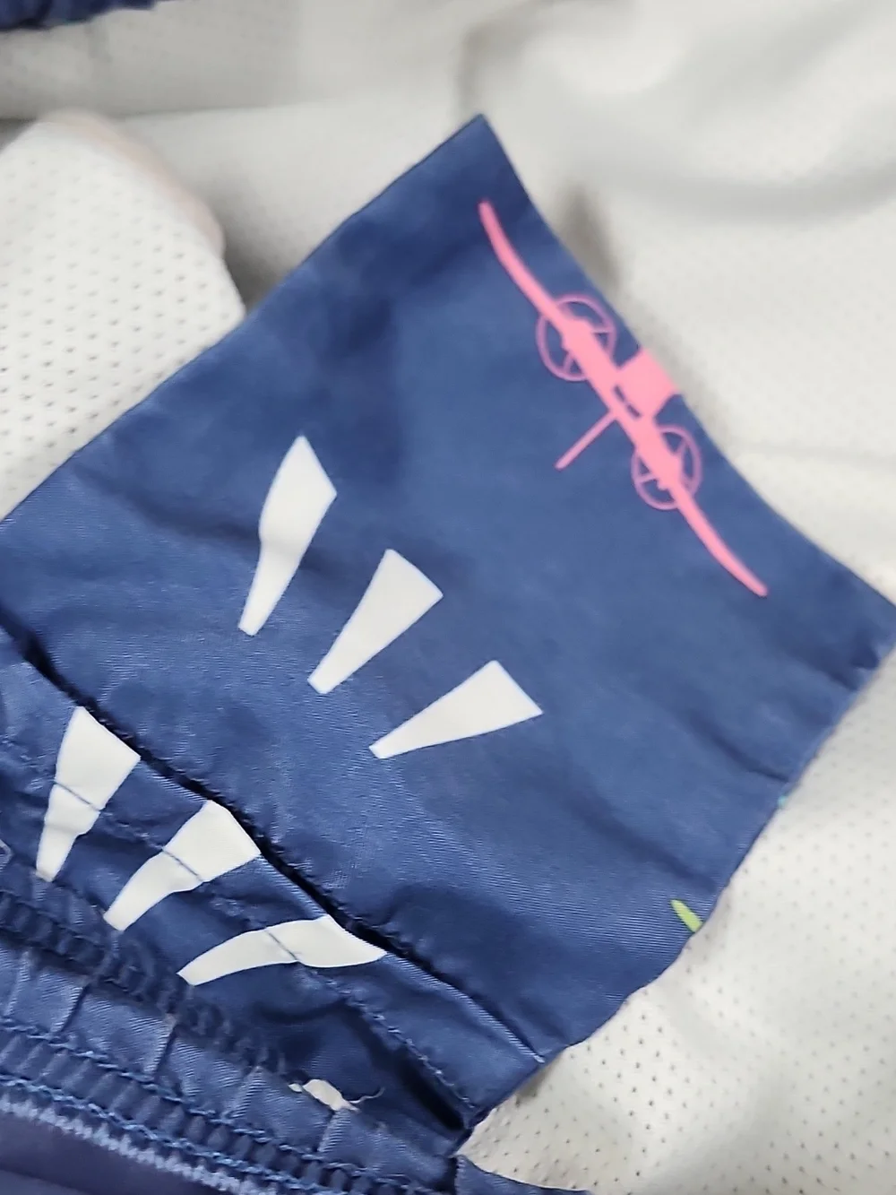 Vineyard Vines Navy Swim Trunks with Pink, Teal & Lime Plane Print