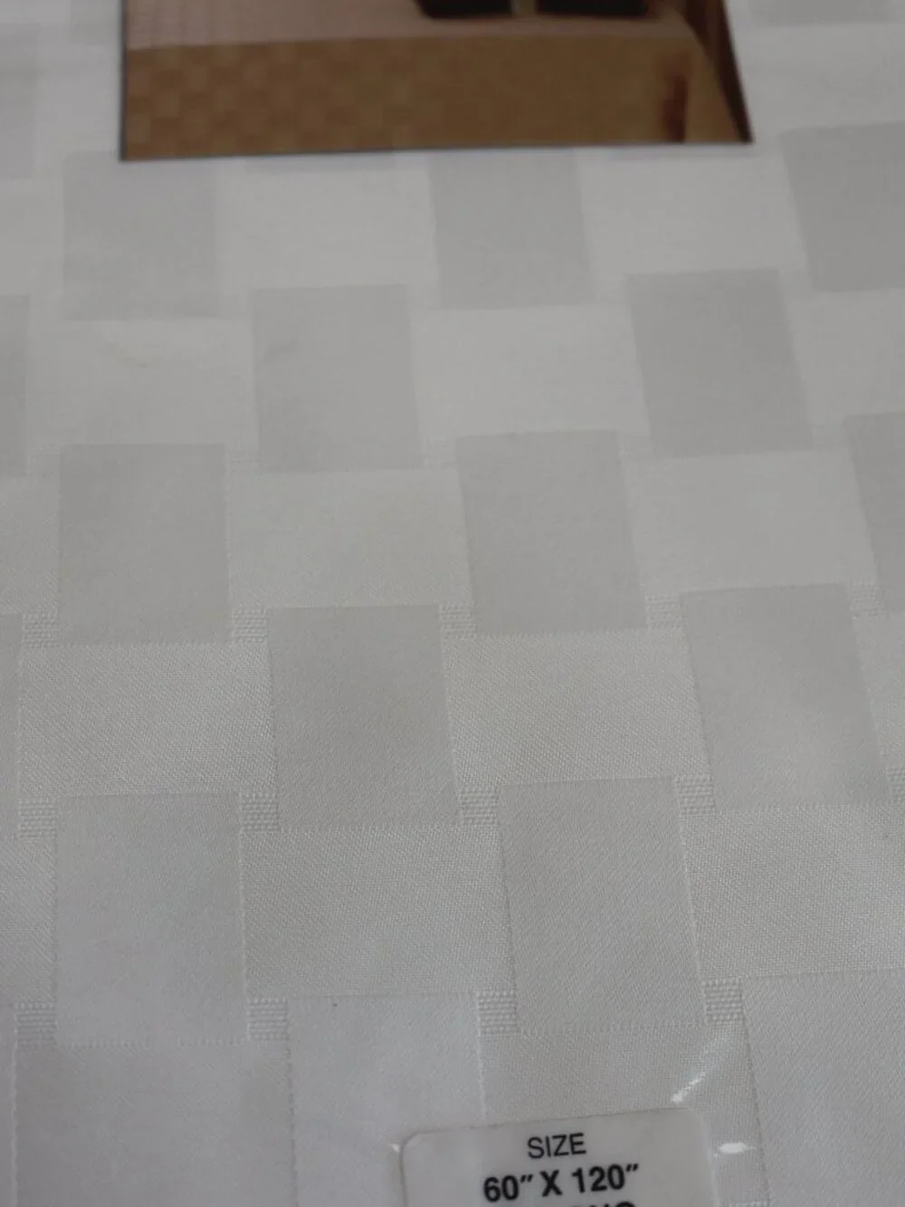 Reflections Microfiber cream checkered tablecloth. New. 60x120.