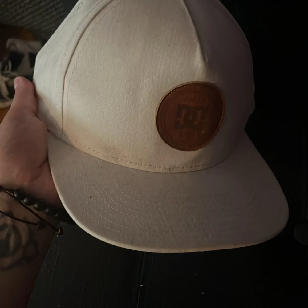 Kids off white colored DV shoes snap back hat some signs of wear see pics.
